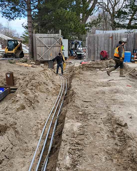 Digging in the ground to lay down electrical solutions